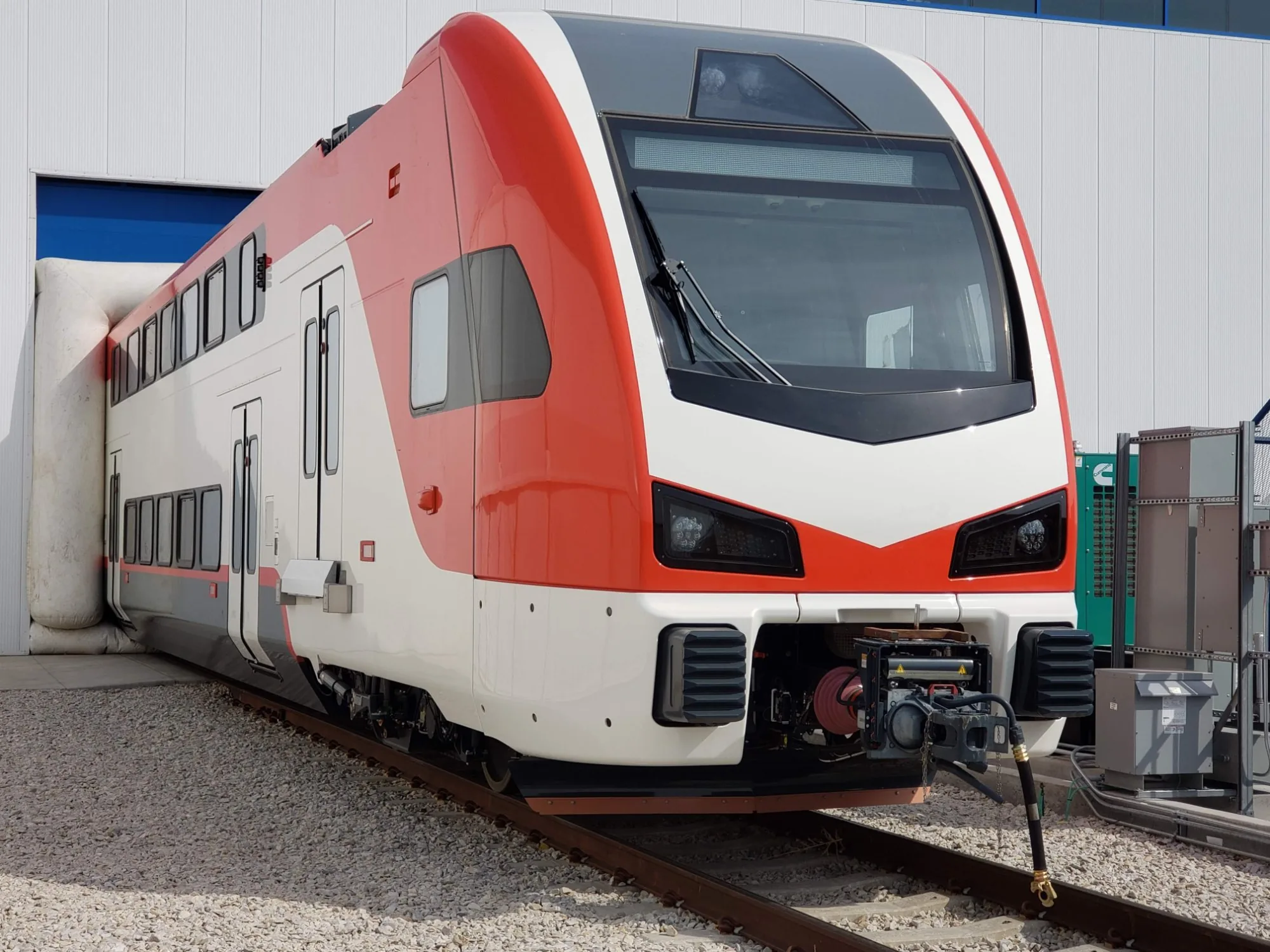 Modern bilevel passenger trainset at a rail facility
